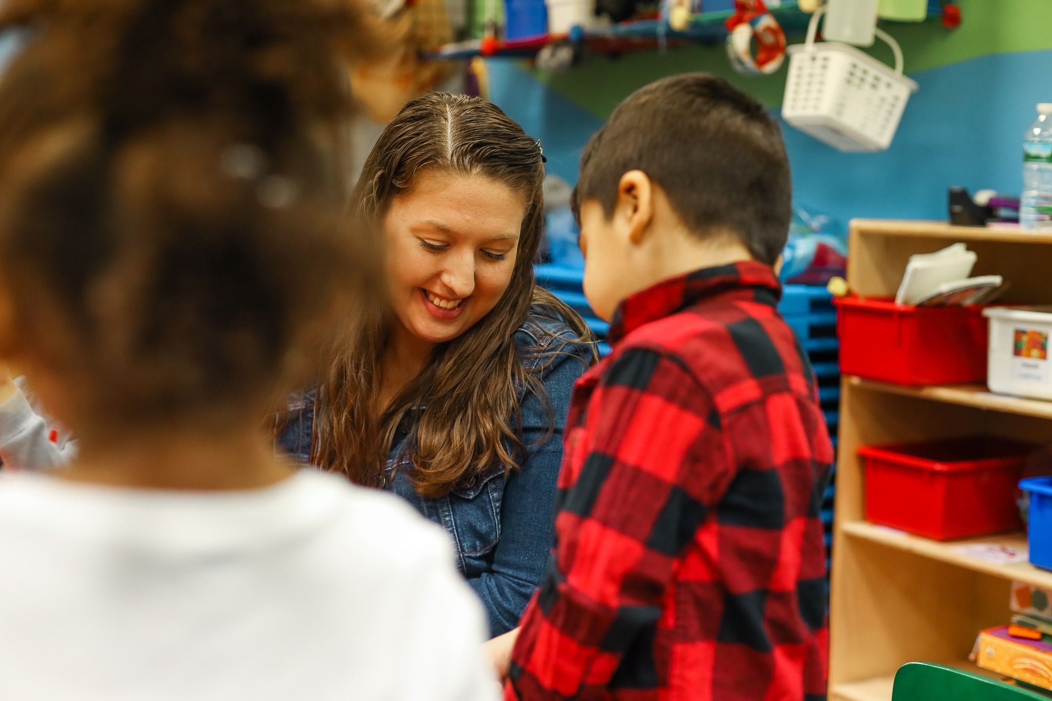 Ms. Gaby reviewing a student's work