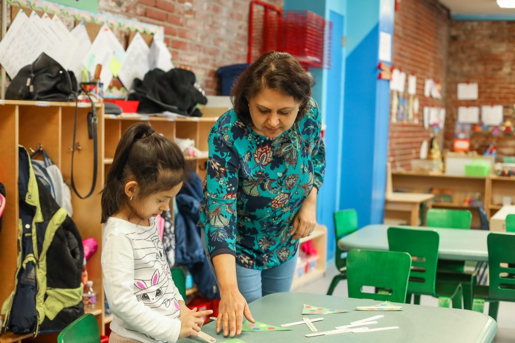 Ms. Anju working with a preschool student